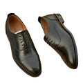 Pair of Louis Vuitton men's black leather Oxford dress shoes with Monogram Flower details shoes on a white background