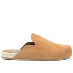 Prada Men’s Interlock Slip-On Flat Mules in black leather with signature logo detail on a white background